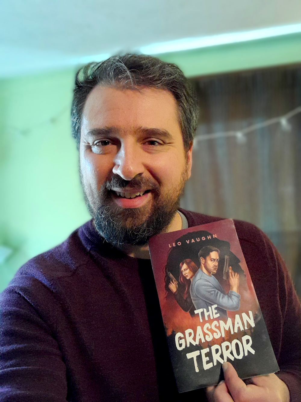 Author Leo Vaughn holding his book, The Grassman Terror